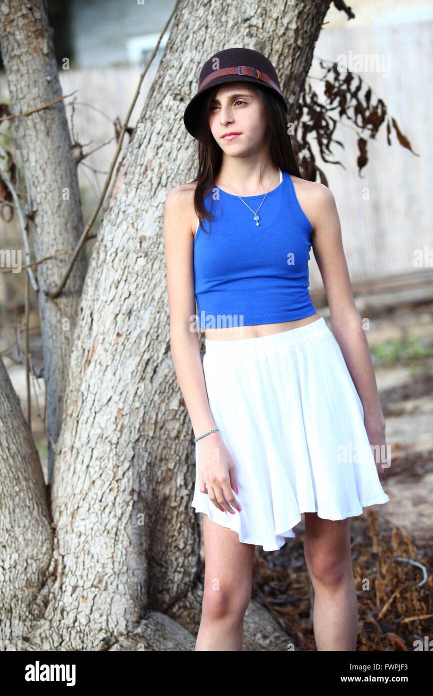 Young twelve year old preteen girl under a tree (model release available) Stock Photo