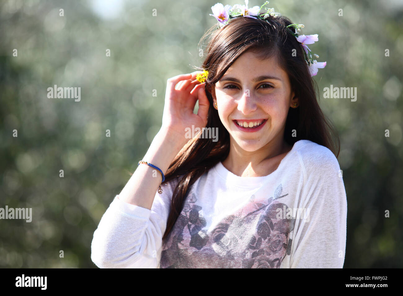 Young twelve year old preteen girl outdoors enjoys nature (model release available) Stock Photo