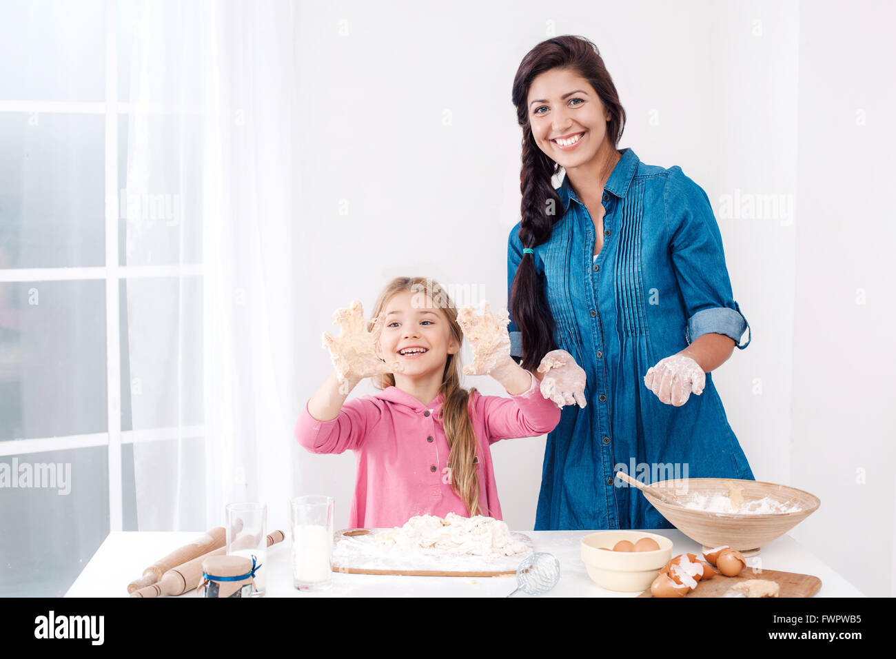Happy mother and daughter baking Stock Photo Alamy