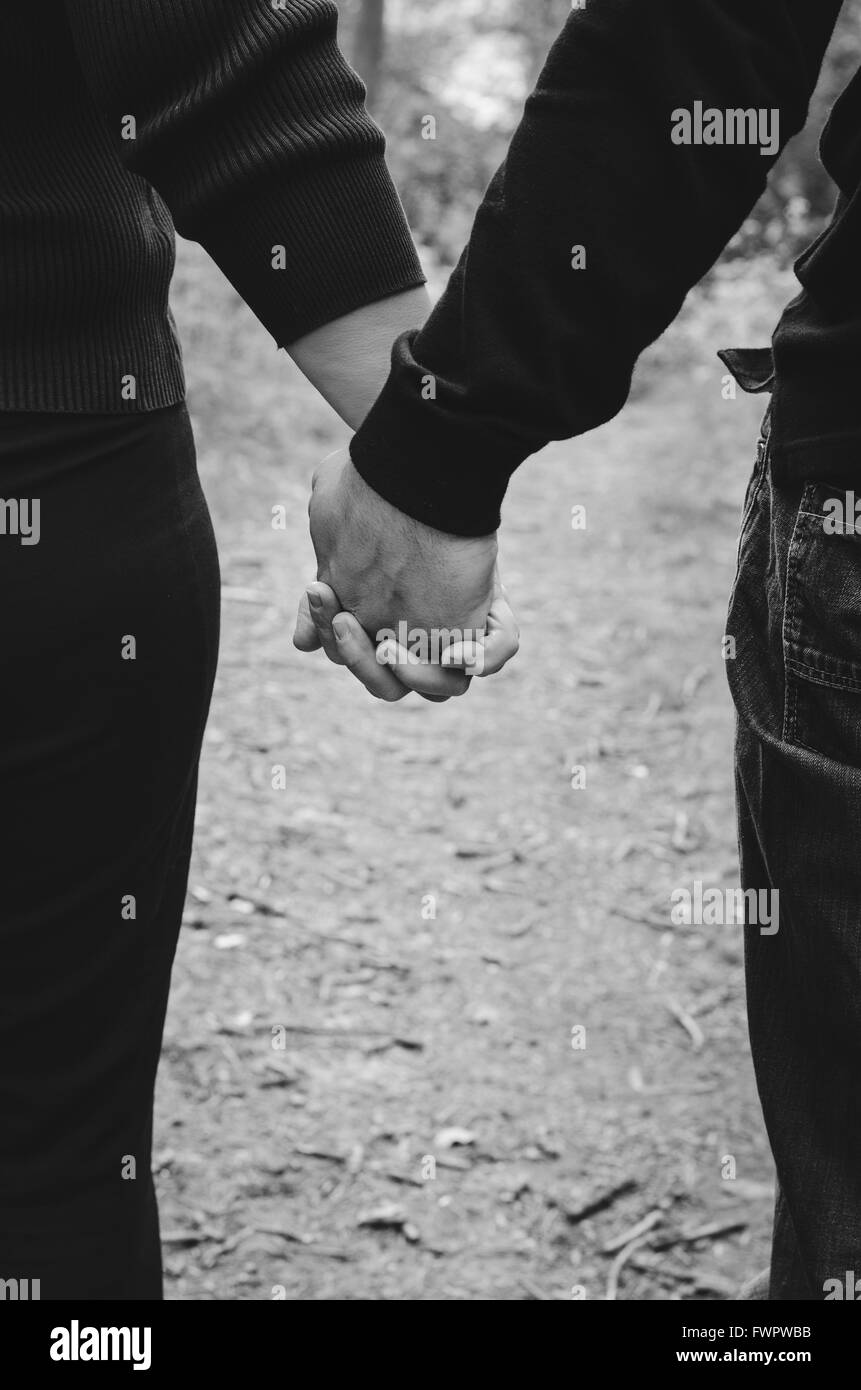 couple holding hands, black and white, outdoors Stock Photo