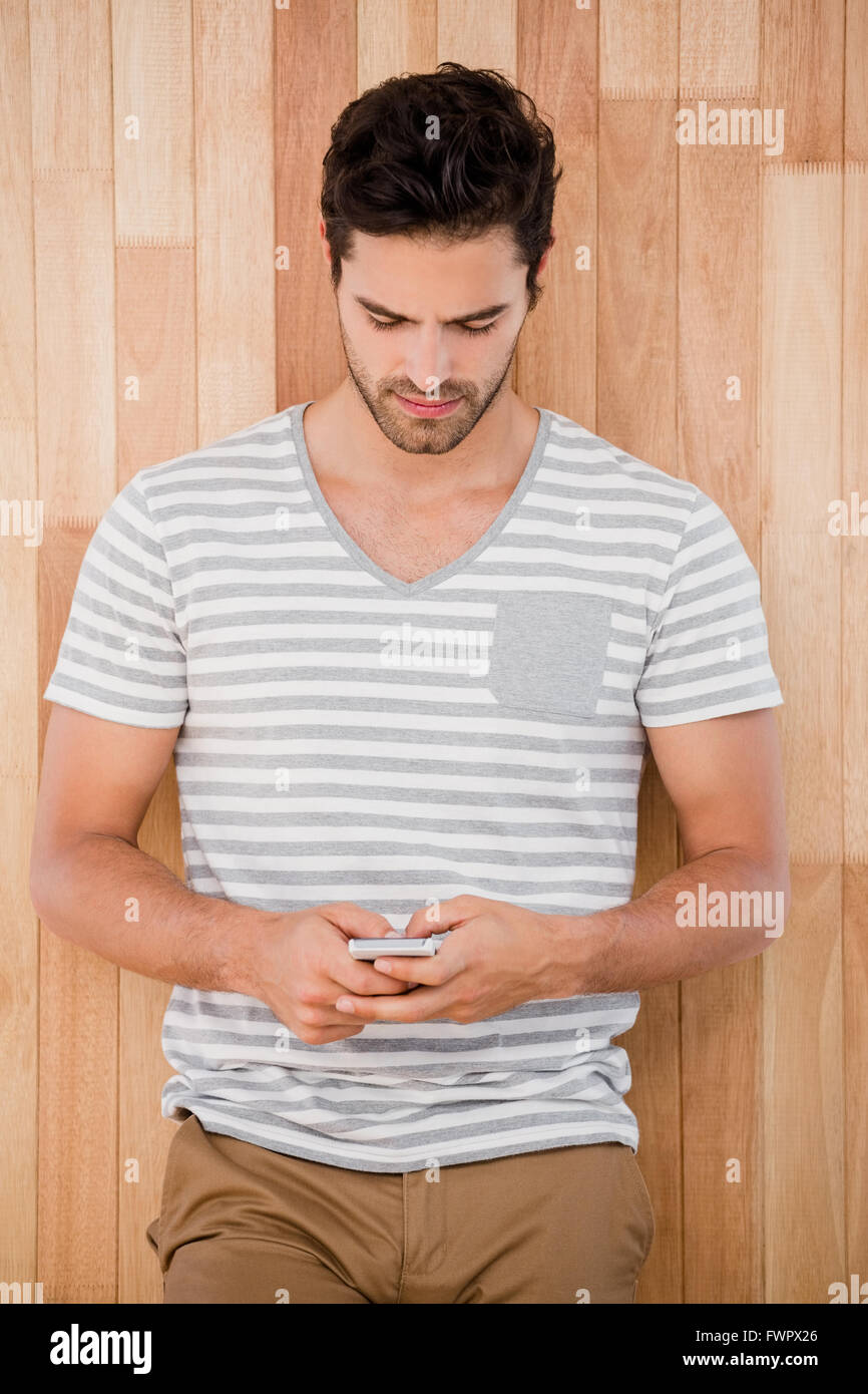 Handsome man typing a text message Stock Photo - Alamy