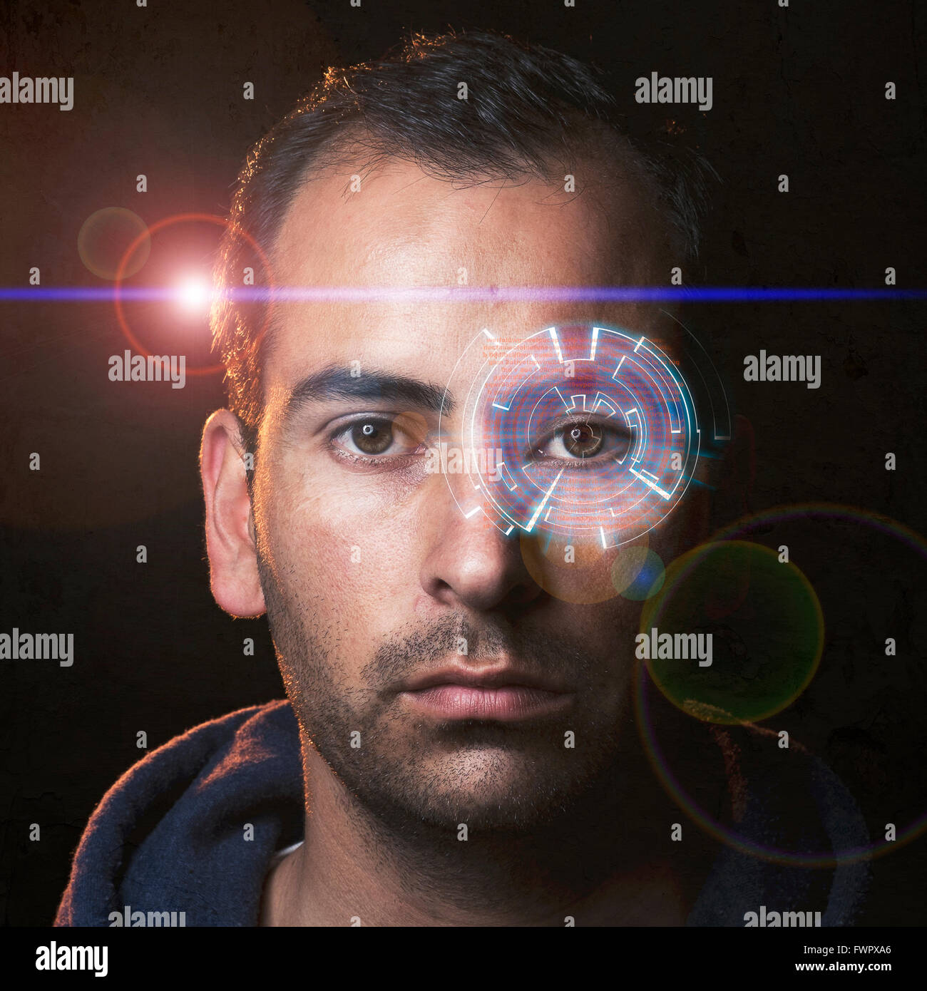 Futuristic portrait of a young man with a hologram in one eye and movie like lens flare Stock Photo