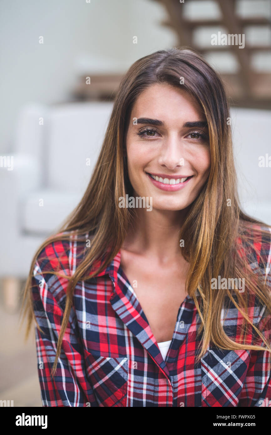 Beautiful woman smiling in living room Stock Photo - Alamy