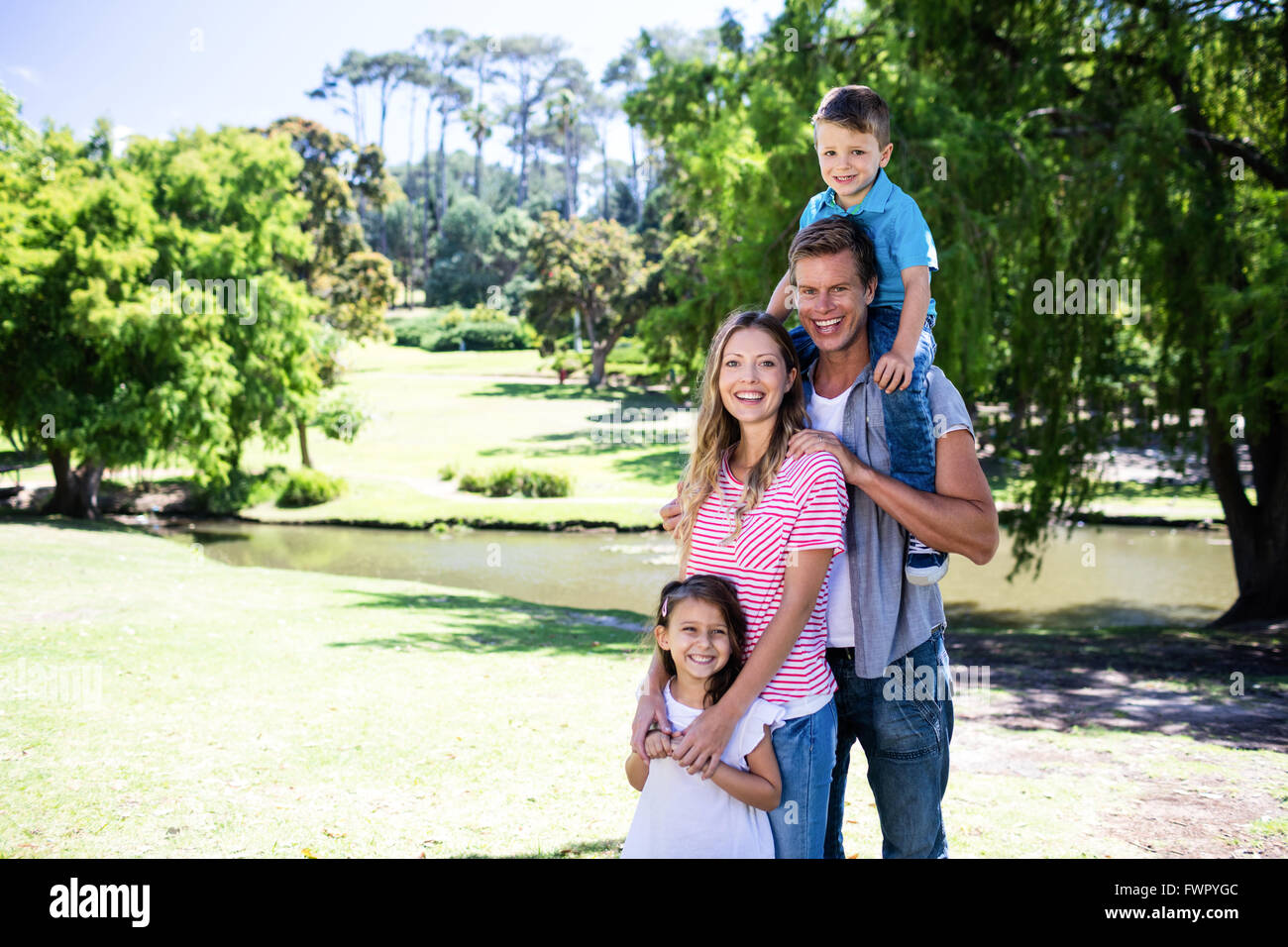 Portrait of a happy family in the park Stock Photo - Alamy