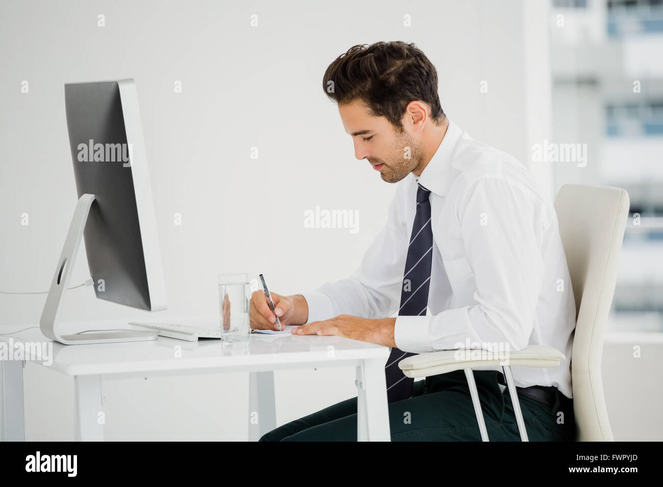 Note Taking Business Computer Businessman using computer and taking notes Stock Photo - Alamy