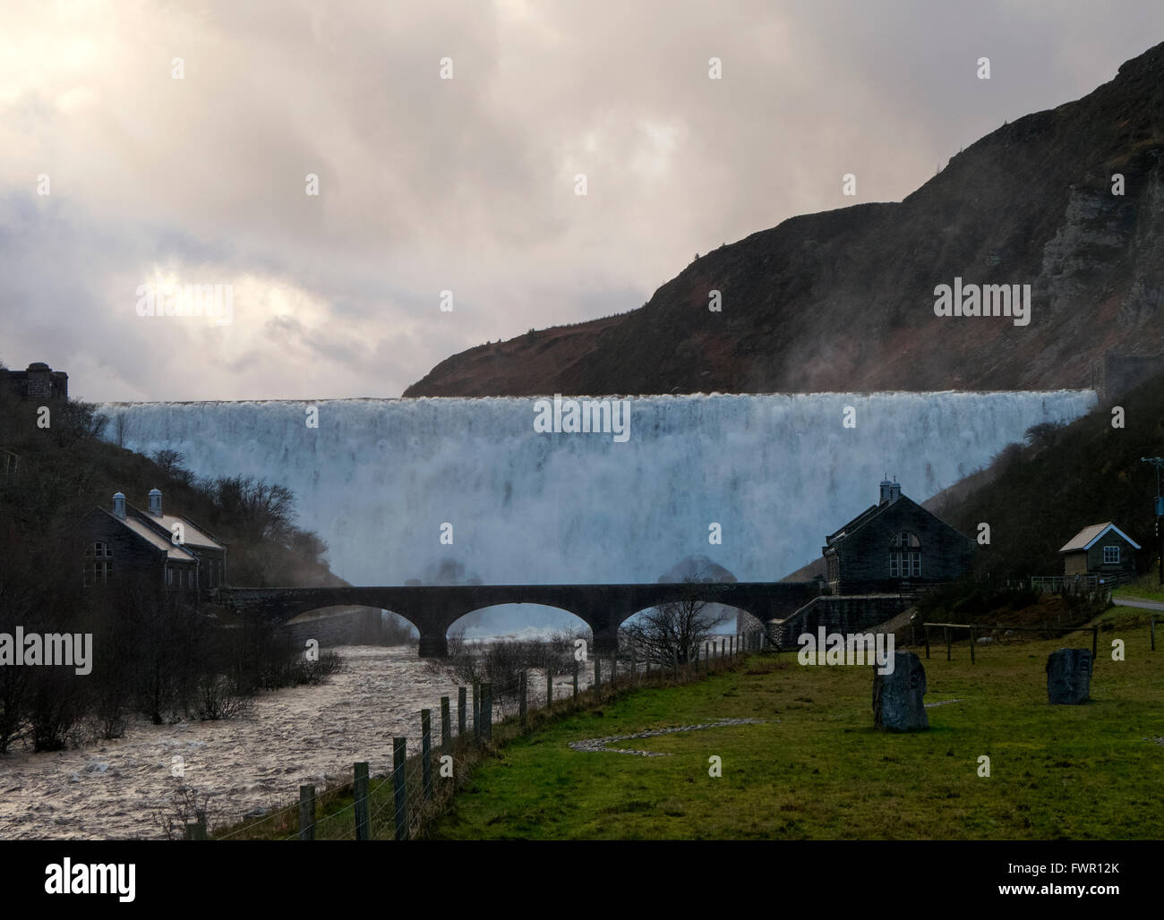 Caban Coch dam spectacular heavy overflowing water in the Elan Valley, Powys Wales UK. Stock Photo
