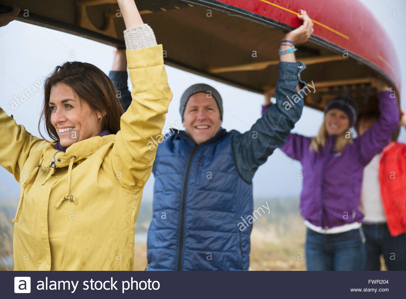 Group of friends carrying canoe over head Stock Photo Alamy