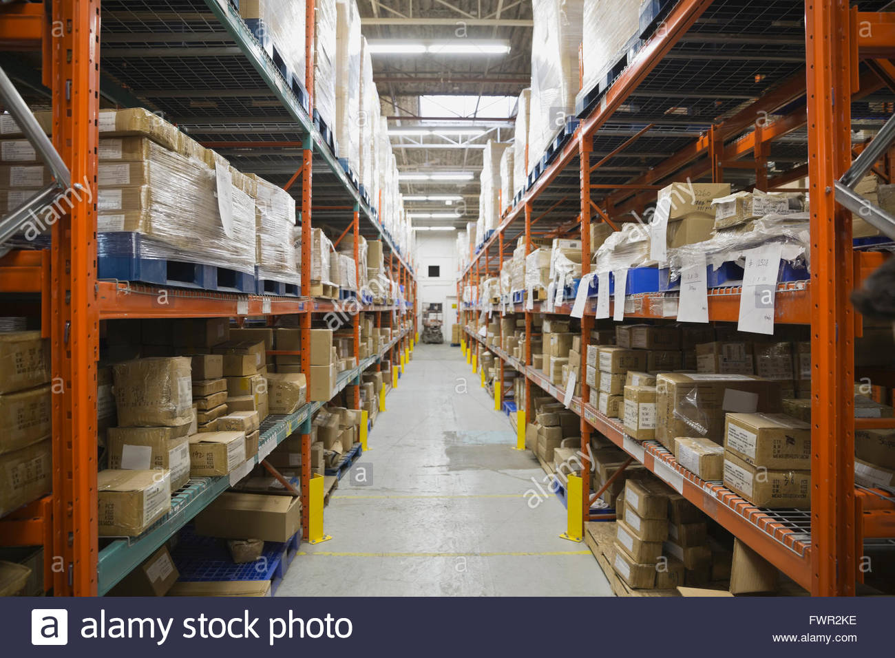 Warehouse aisle with shelving and boxes Stock Photo