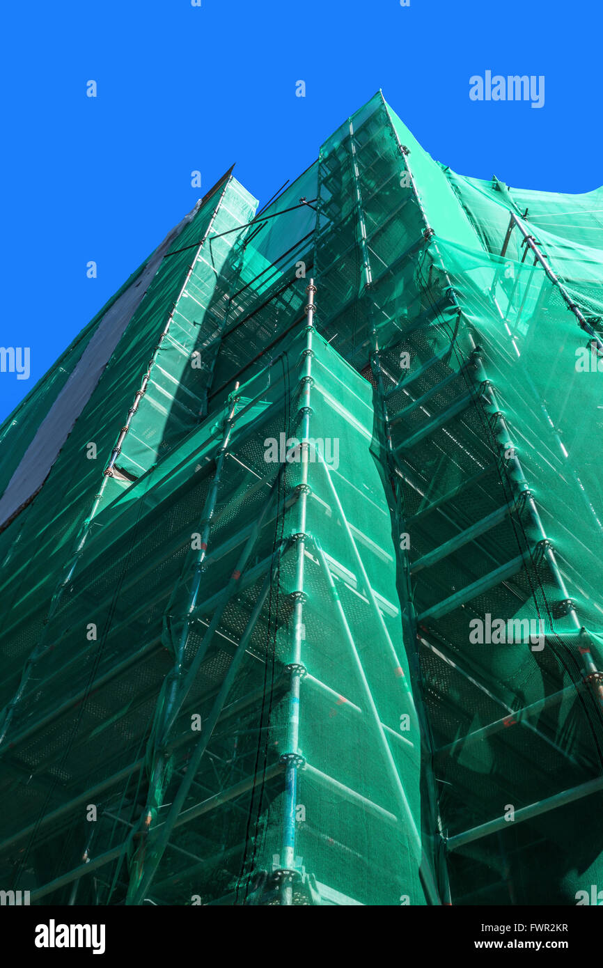 Scaffolding with green safety net Stock Photo Alamy