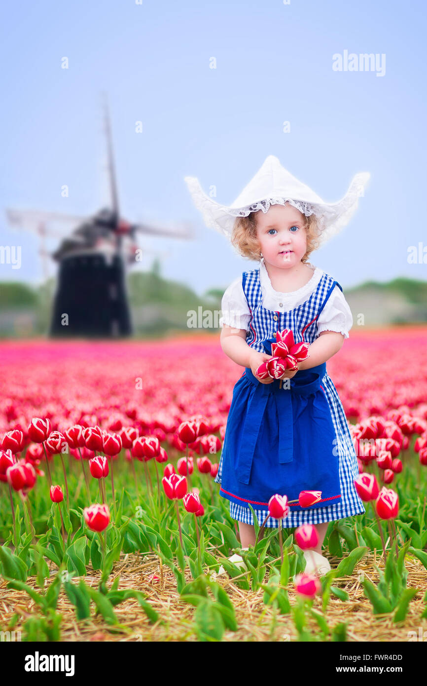 Adorable curly toddler girl wearing Dutch national costume dress and ...