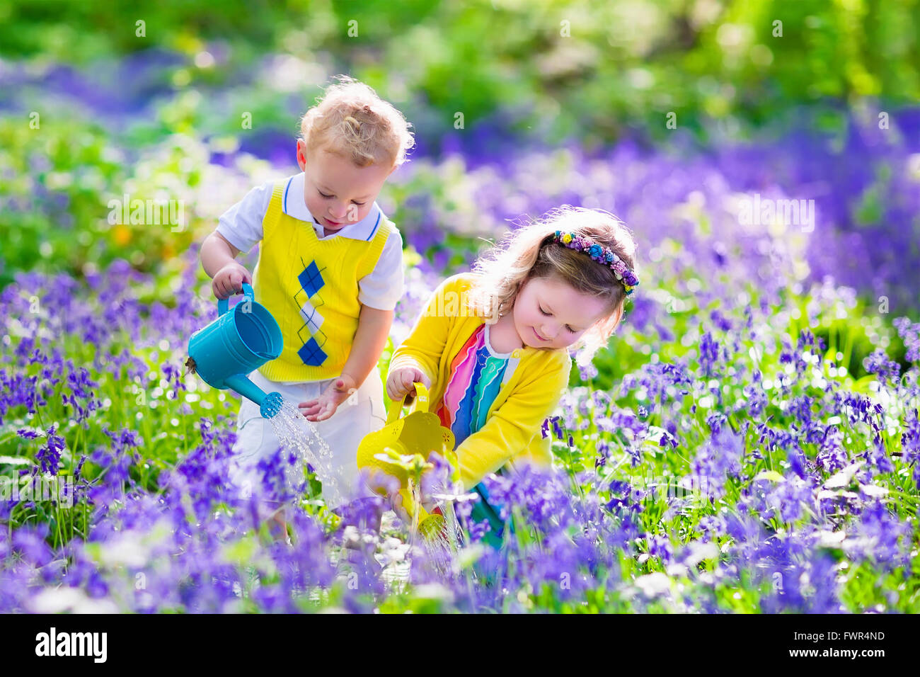 Kids gardening. Children playing outdoors. Little girl and baby boy