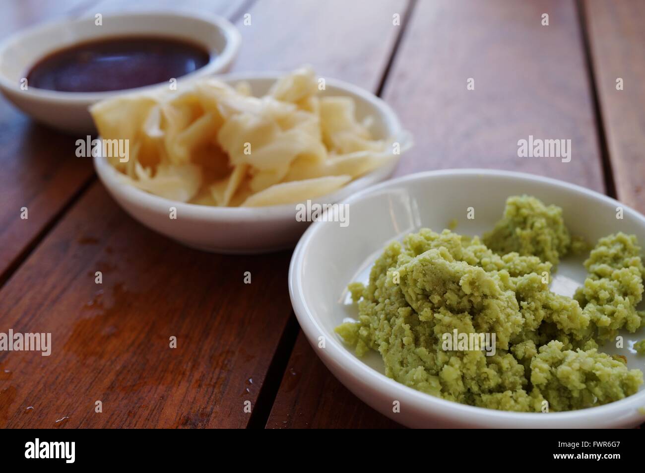 Dishes of green wasabi, pickled ginger and soy sauce Japanese