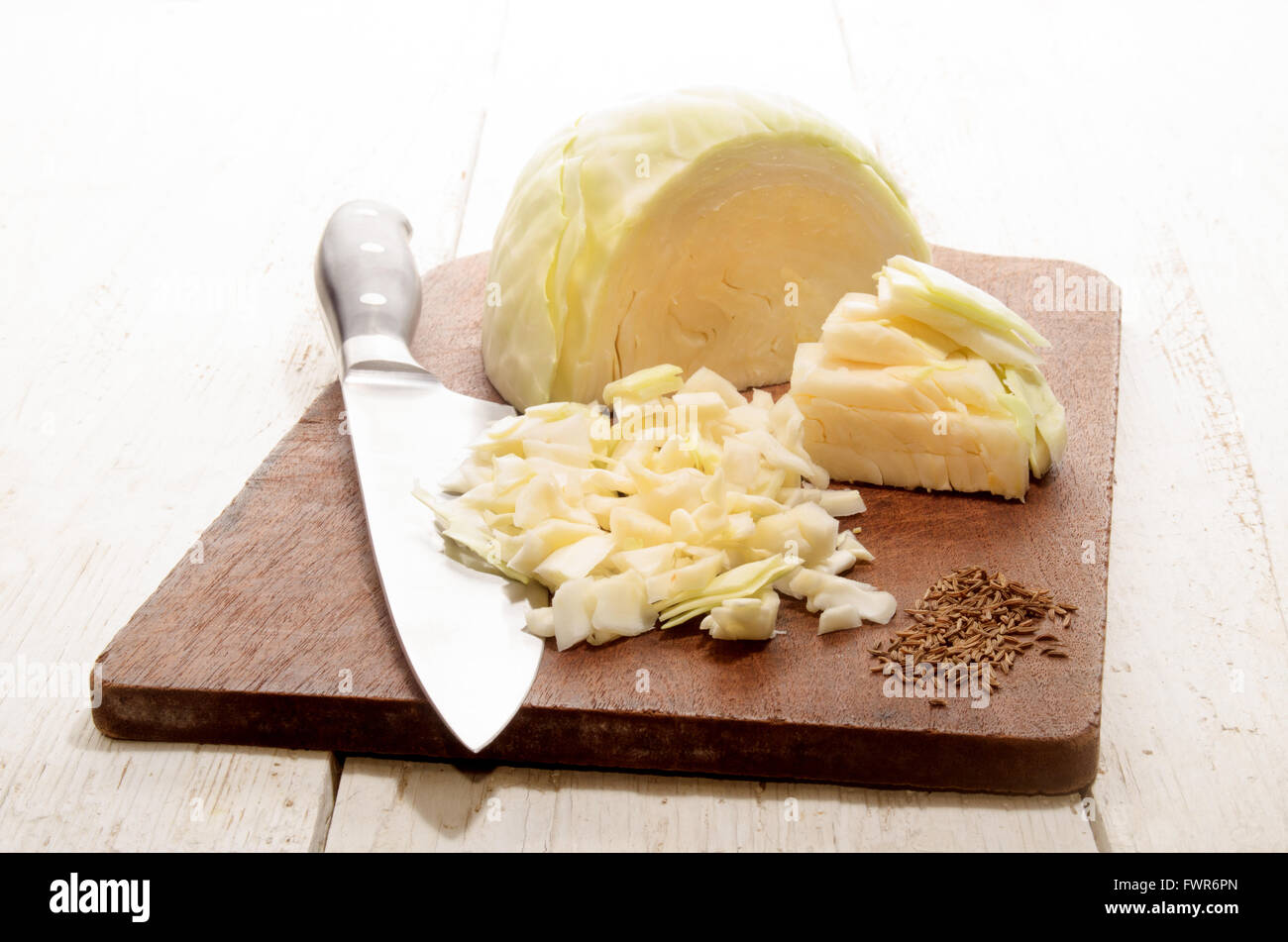 chopped white cabbage and caraway seed on wooden board Stock Photo