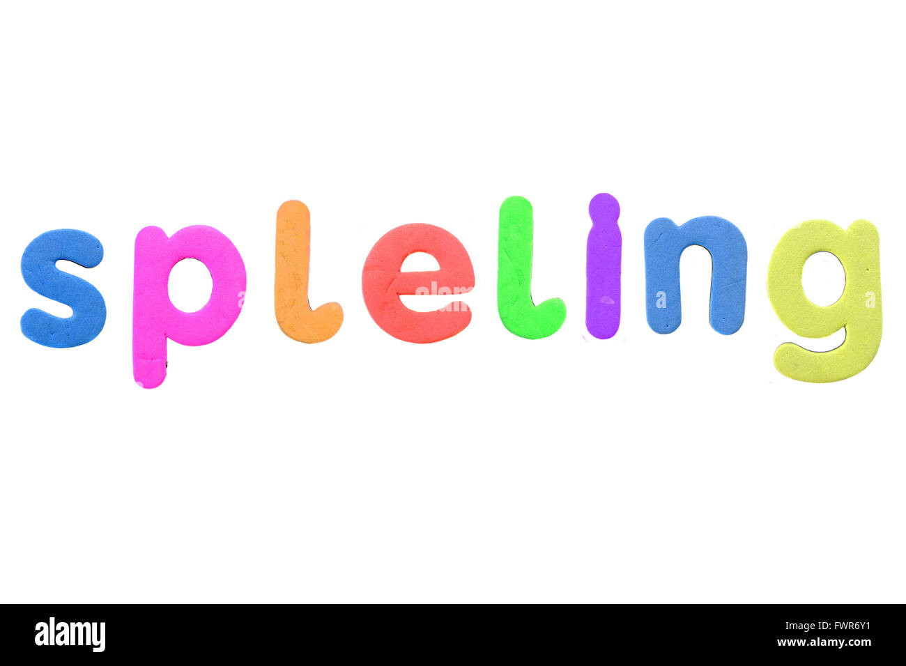 The word spelling (misspelt) created from alphabetic fridge magnets against a white background. Stock Photo