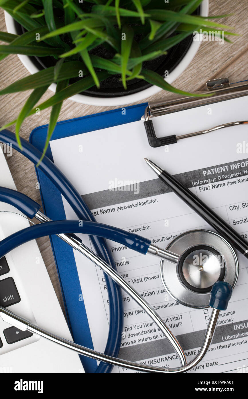Doctor Table View Close-up view of medical doctor’s working table. Laptop, stethoscope ...