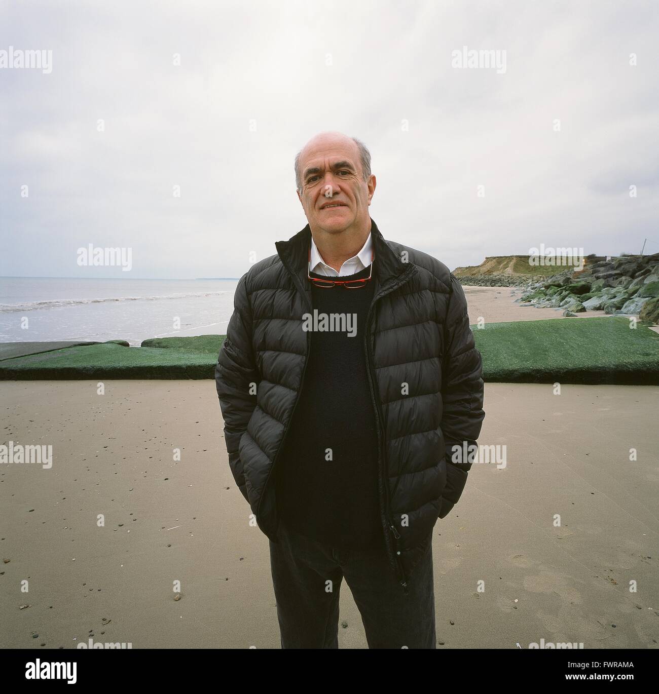 Irish author, Colm Toibin, on the strand at Ballyconnigar, Enniscorthy, County Wexford, a location which features in several of his novels Stock Photo