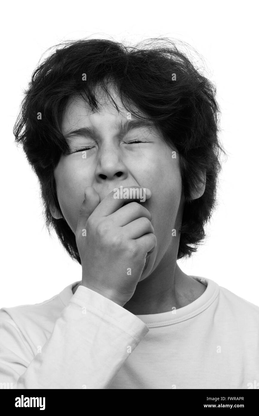 Portrait of a yawning young boy in black and white Stock Photo