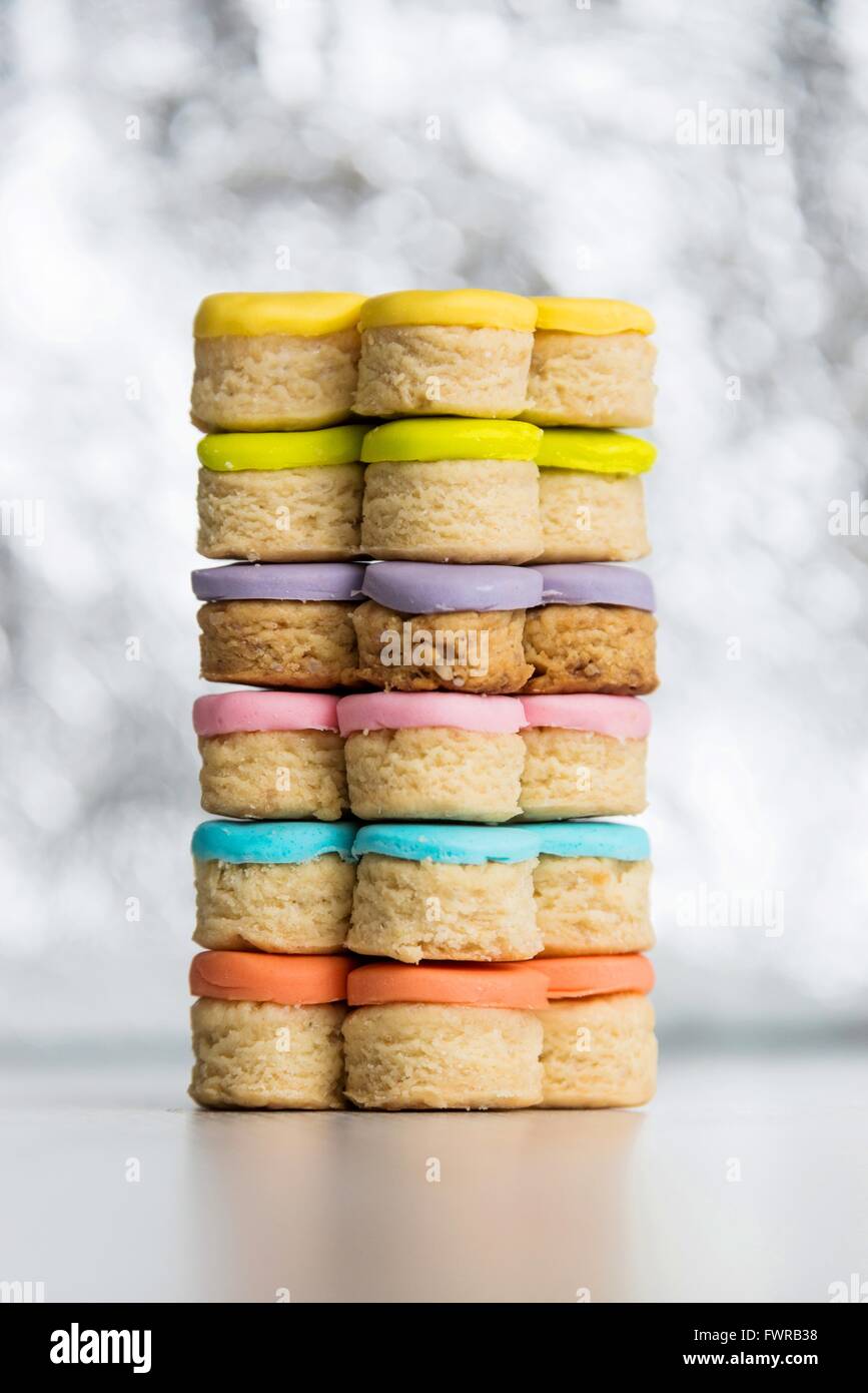 Closeup of colorful homemade fondant covered cookies on a shiny light background Stock Photo
