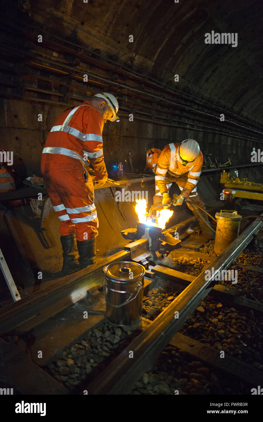 Engineers weld replacement track components together using thermite