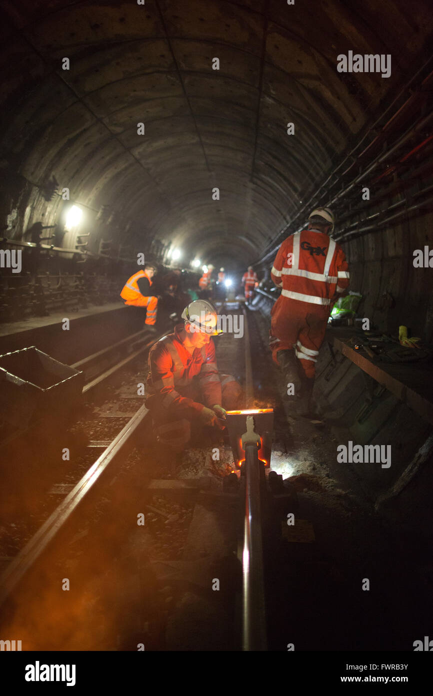 Engineers weld replacement track components together using thermite welding on London