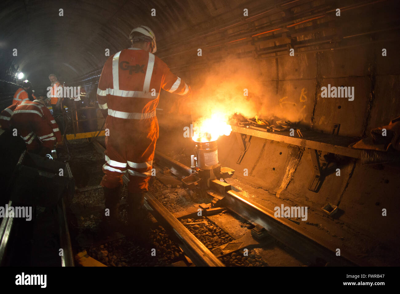 Engineers weld replacement track components together using thermite welding on London