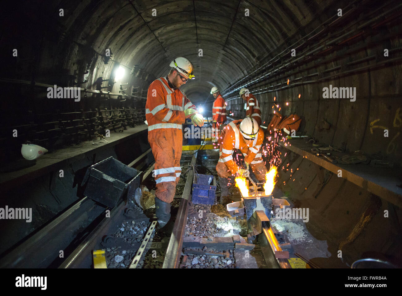 Engineers weld replacement track components together using thermite