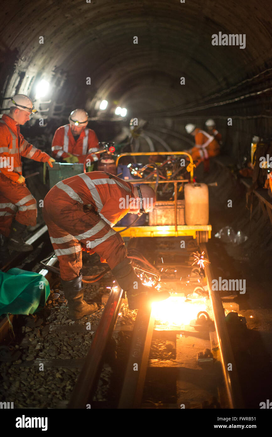 Engineers weld replacement track components together using thermite welding on London