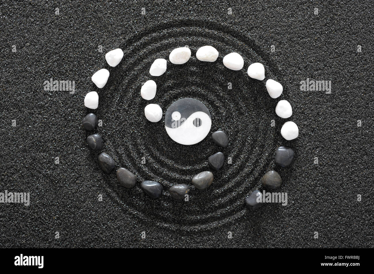 Japanese ZEN garden with yin and yang stone in raked sand Stock Photo
