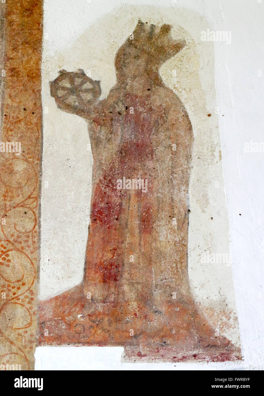 A medieval wall painting of St Catherine with her wheel in the church of St Margaret at Hardley, Norfolk, England, UK. Stock Photo