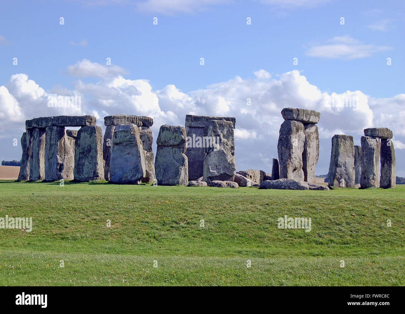 The stone circle at Stonehenge, looks magnificent, beneath a blue sky complete with fluffy white clouds, england, uk Stock Photo