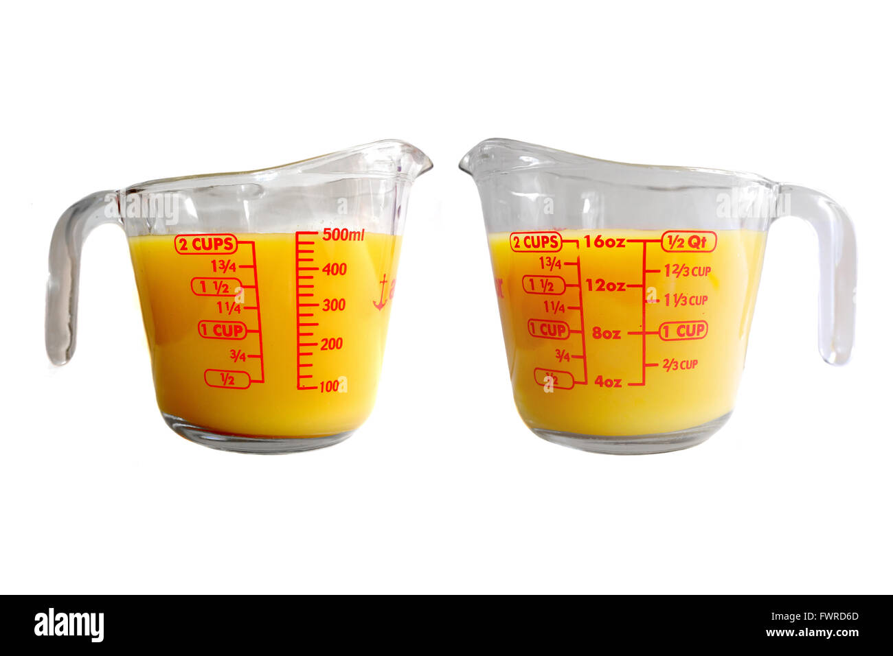 Download Two Side Of A Measuring Jug Full Of Yellow Liquid Photographed Stock Photo Alamy PSD Mockup Templates