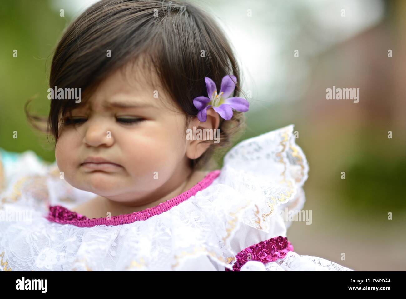 One year old girl dressed up with the traditional Colombian dress from the Huila Region. Stock Photo