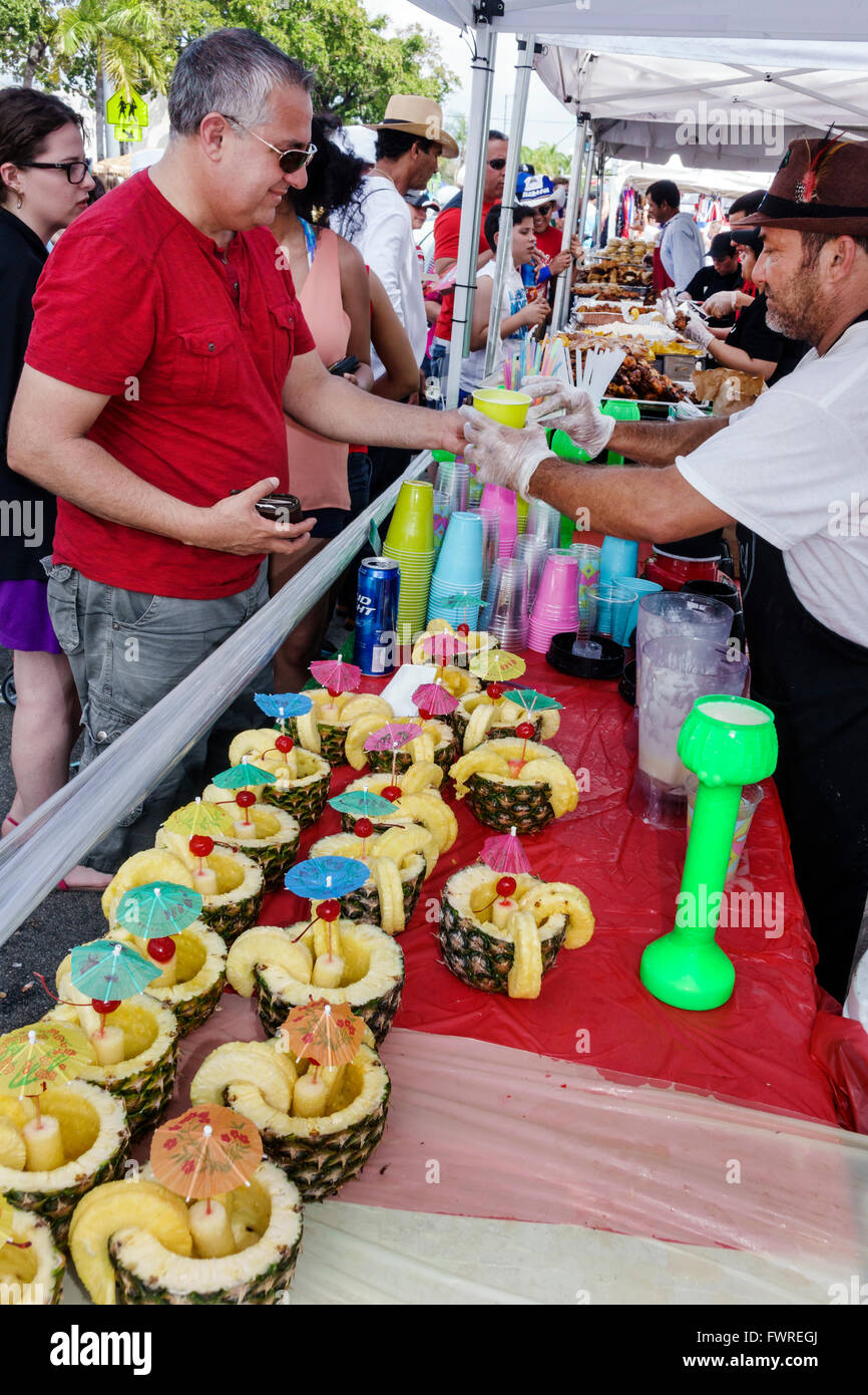 Miami Florida,Little Havana,Calle Ocho,annual street festival,Hispanic vendors,booths,stalls,Pina colada,transaction paying pays buying buys,selling,d Stock Photo