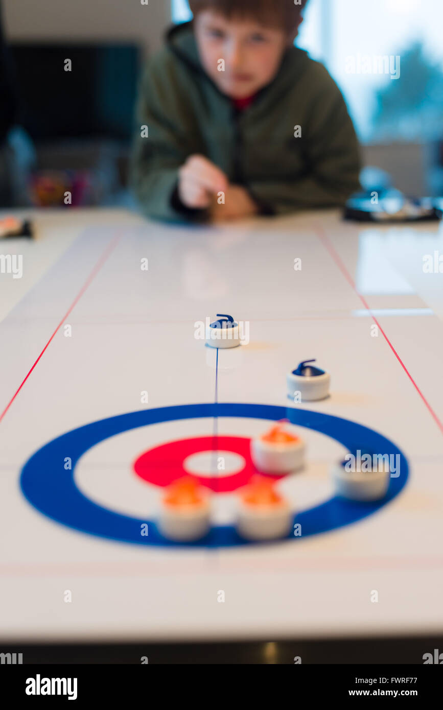 Table curling game being played by child Stock Photo Alamy