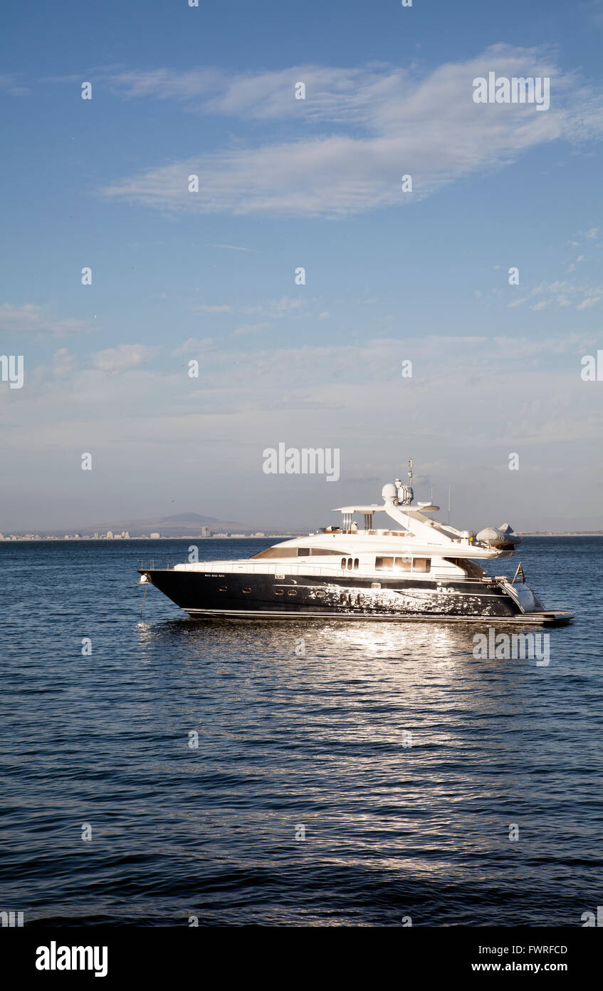 Yacht Moored at Sea alongside Grand Beach Cafe in Granger Bay - Cape Town - South Africa Stock Photo