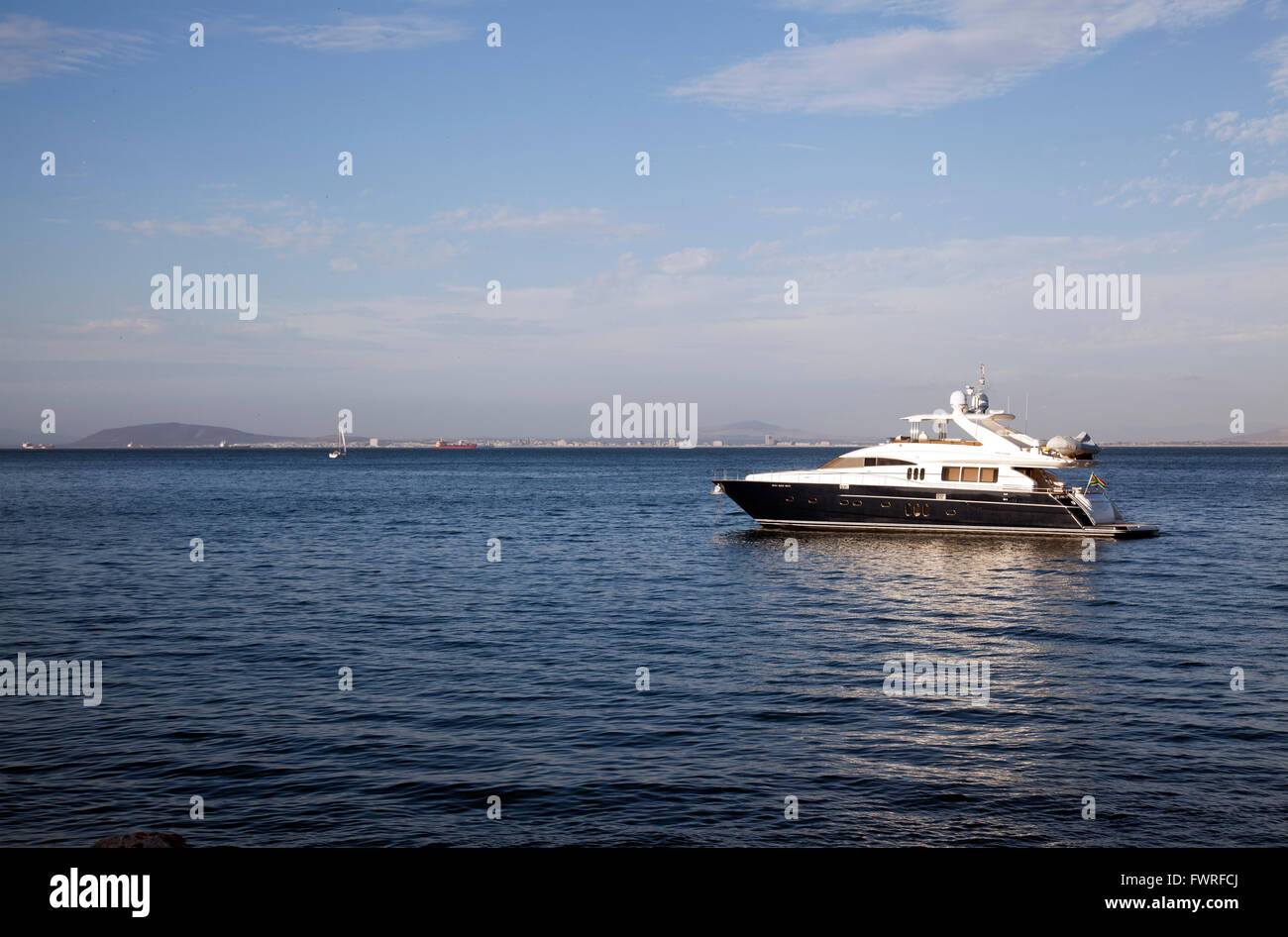Yacht Moored at Sea alongside Grand Beach Cafe in Granger Bay - Cape Town - South Africa Stock Photo