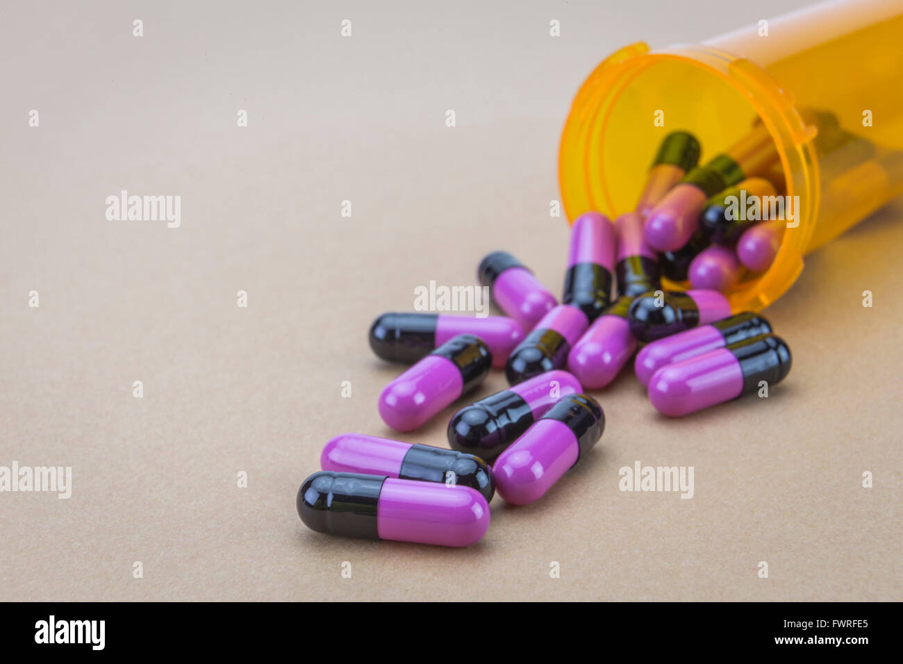 Pills spilling from an open bottle Stock Photo