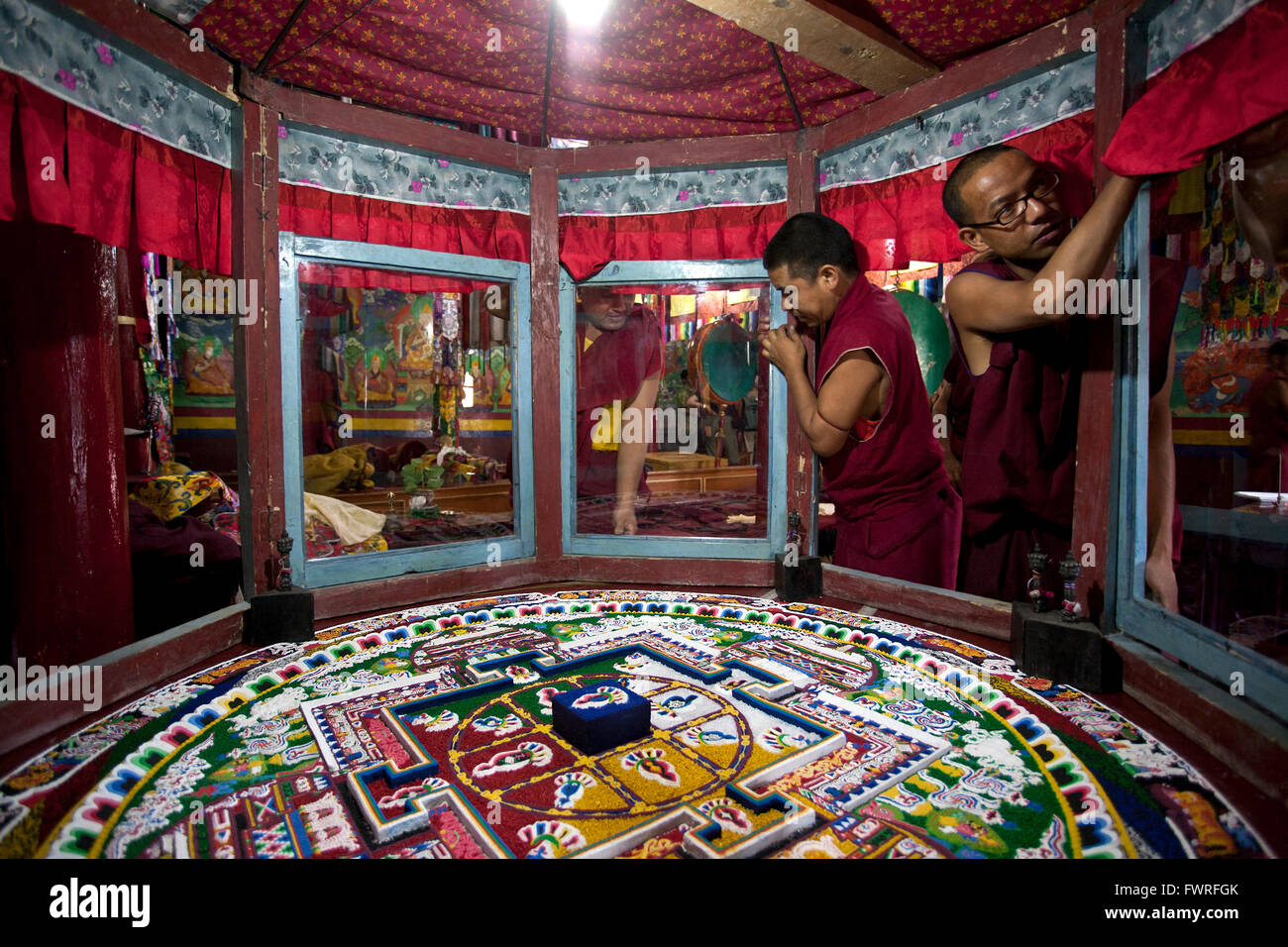 Buddhist monks finishing a sand mandala. Spituk Gompa. Ladakh. India Stock Photo