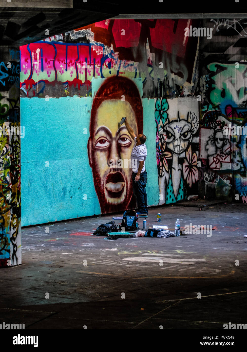 Graffiti artist in London finishing his piece Stock Photo Alamy