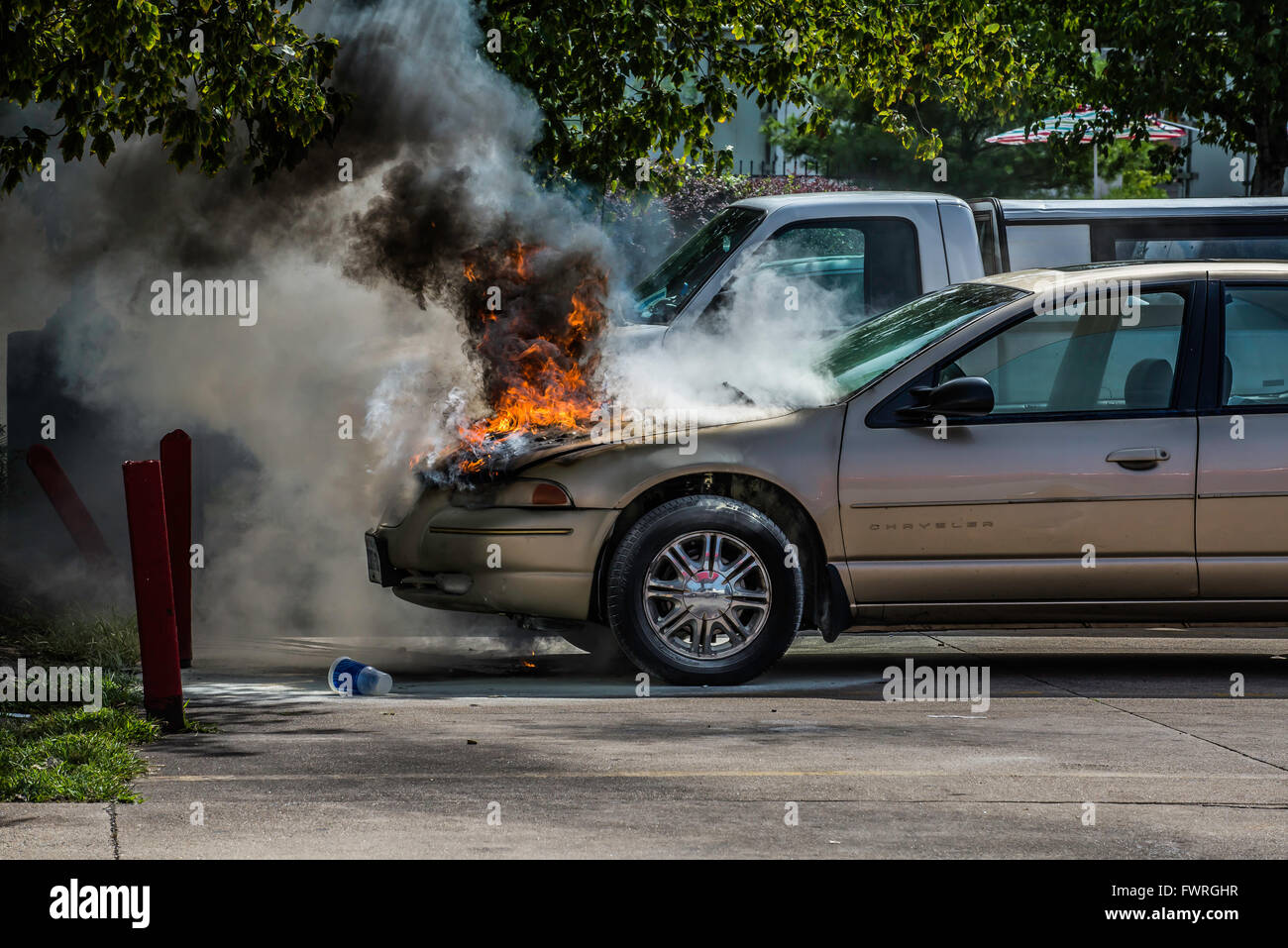 Car fire in parking lot of service station, fast food market Stock Photo Alamy