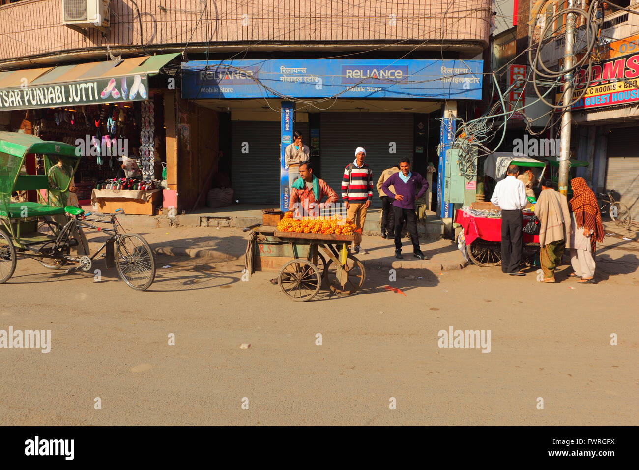 Street scene in the old part of Amritsar city in Punjab, India with people visiting shops and street vendors. Stock Photo