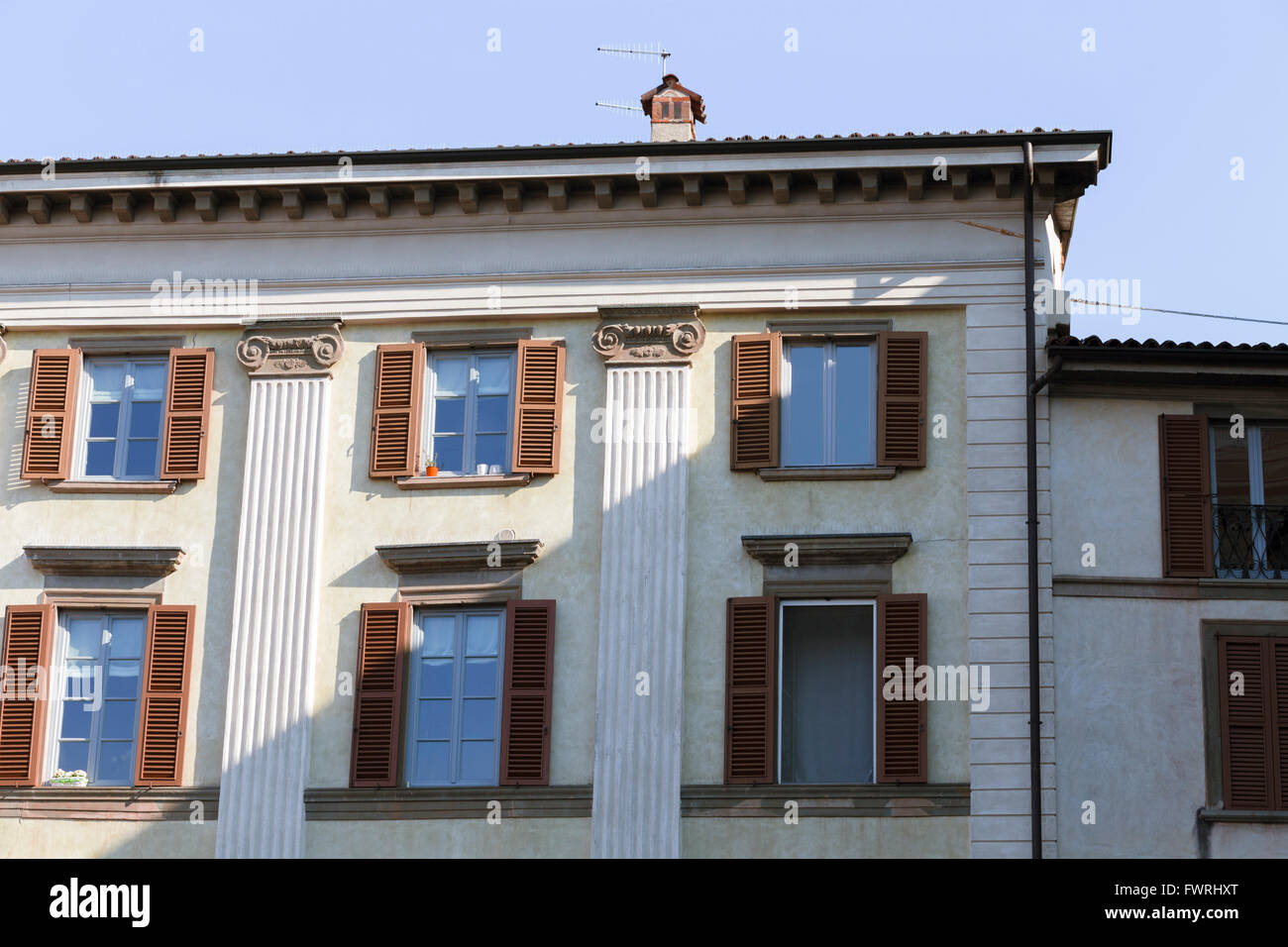 Neoclassical Ionic pilasters on an apartment building (palazzo) in the Piazza Vecchia, Bergamo, Italy. Stock Photo