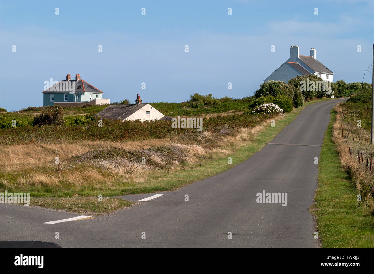 An empty road with houses on the island of Alderney. Stock Photo