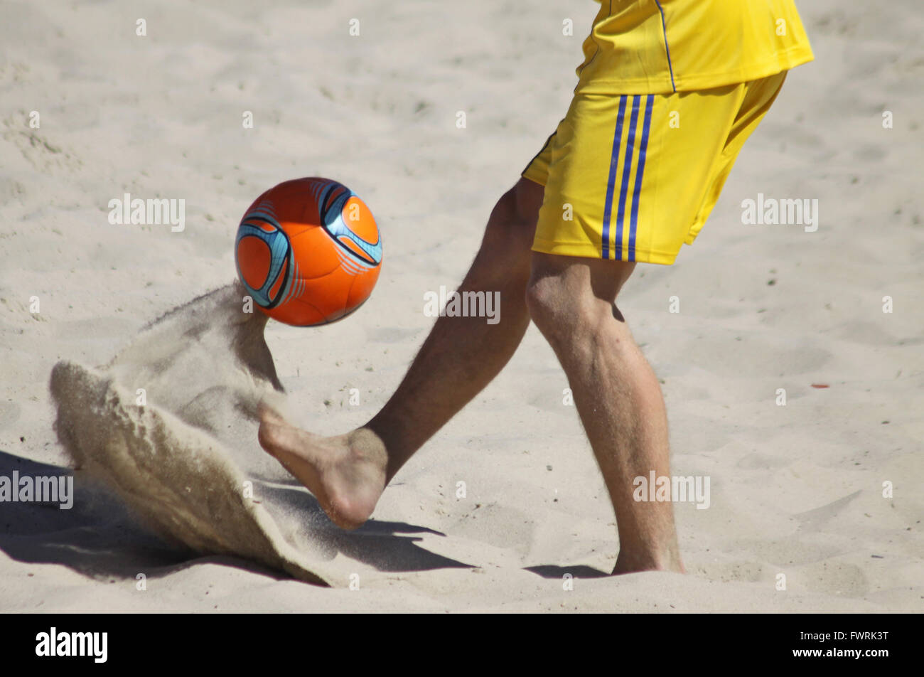 Man playing football on a beach Stock Photo