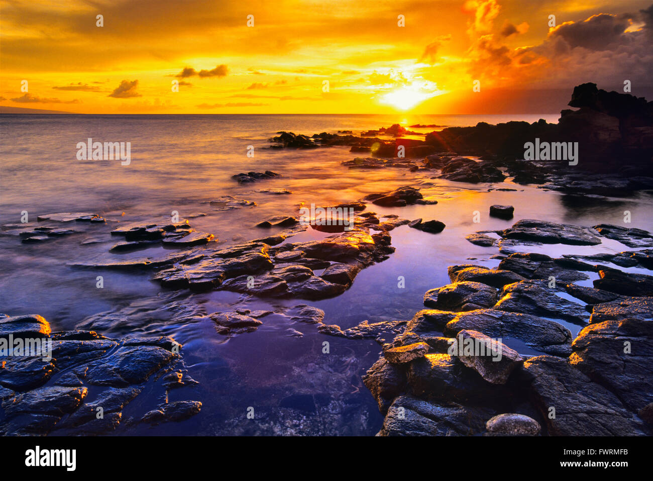 Rocky shore at sunset on Maui Stock Photo - Alamy