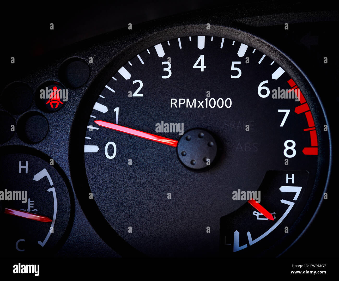 Close of up car tachometer with temperature guage, battery guage and