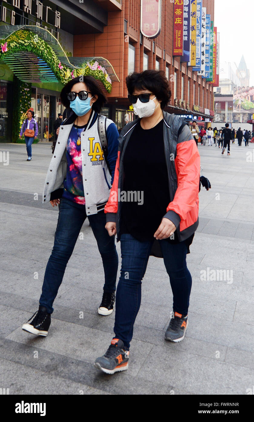 Residents of Beijing wear breathing masks do to bad pollution. Stock Photo
