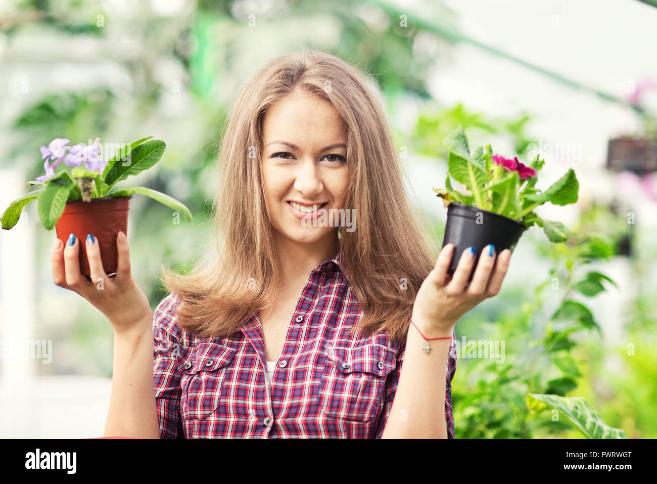 Woman in greenhouse hi-res stock photography and images - Alamy