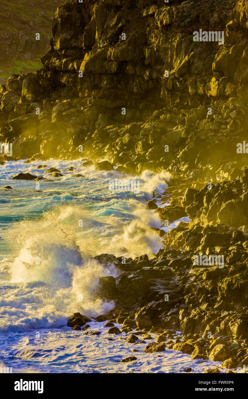 waves pounding cliffs at Poelua bay, Maui at sunrise Stock Photo