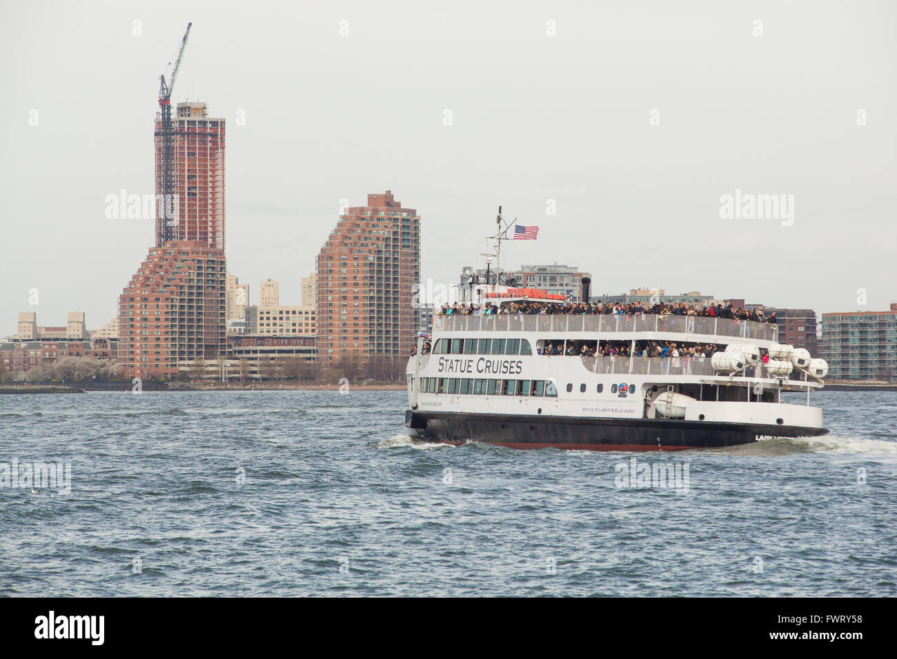 Statue Cruises passenger ferry taking tourists to the Statue of Liberty